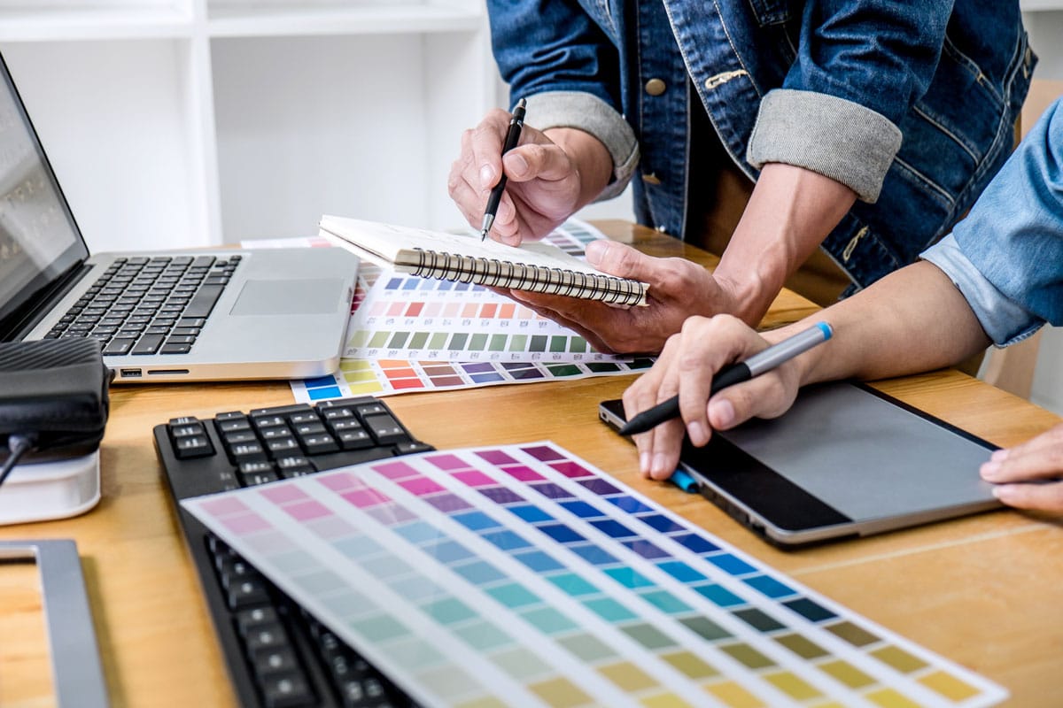 Two graphic designers working on a creative graphic design project.